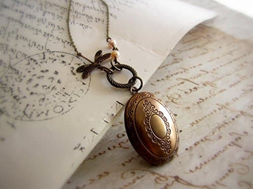 Dragonfly locket necklace in antique bronze with doily patterned lid and ivory glass pearls