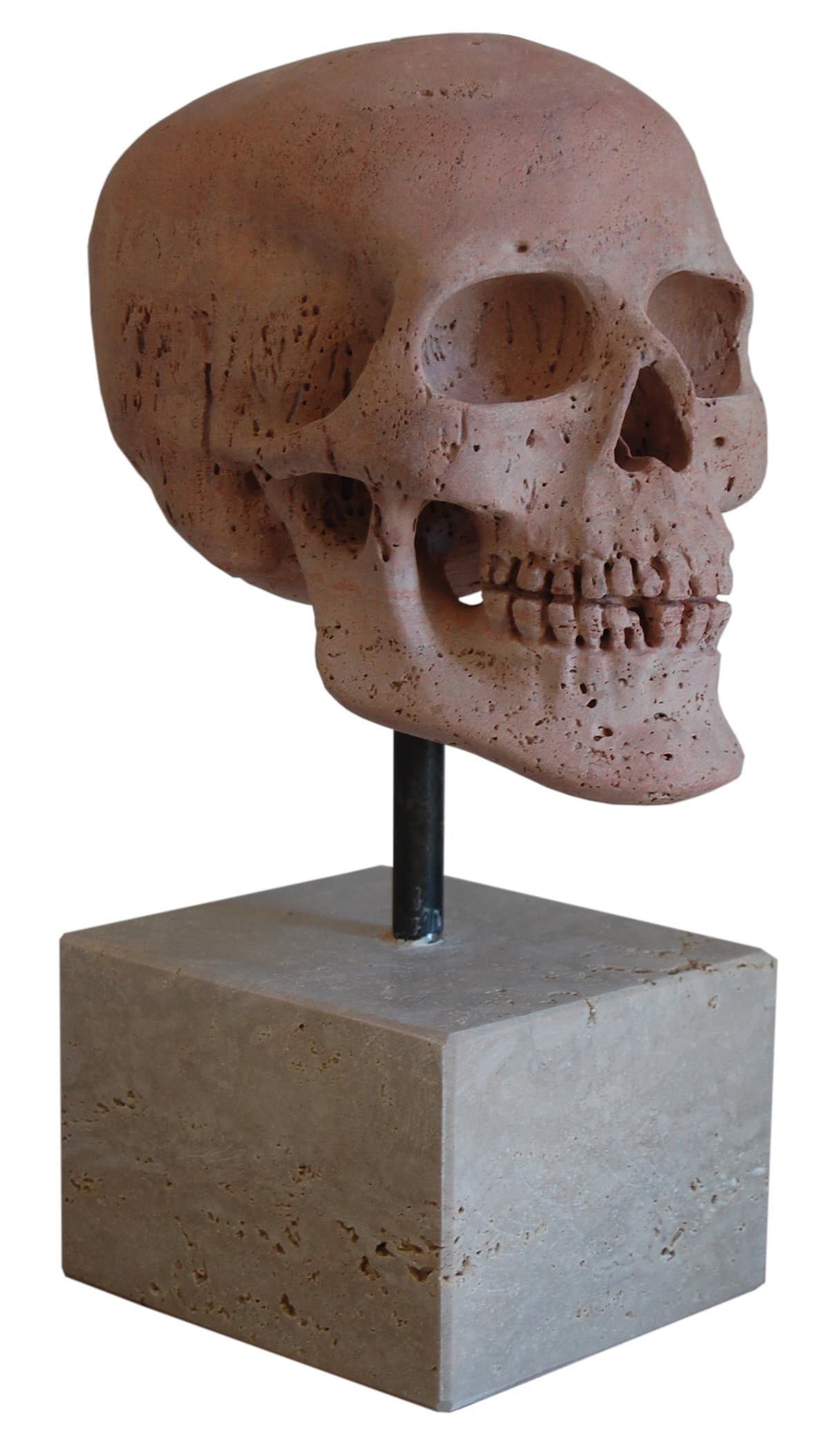 Skull, head sculpture carved on a red travertine stone