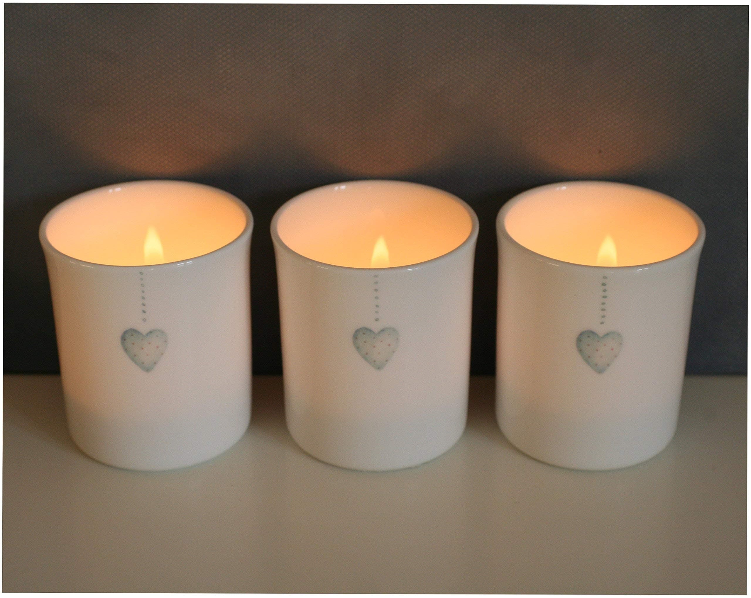A set of three bone china tea light holders with little blue hearts.