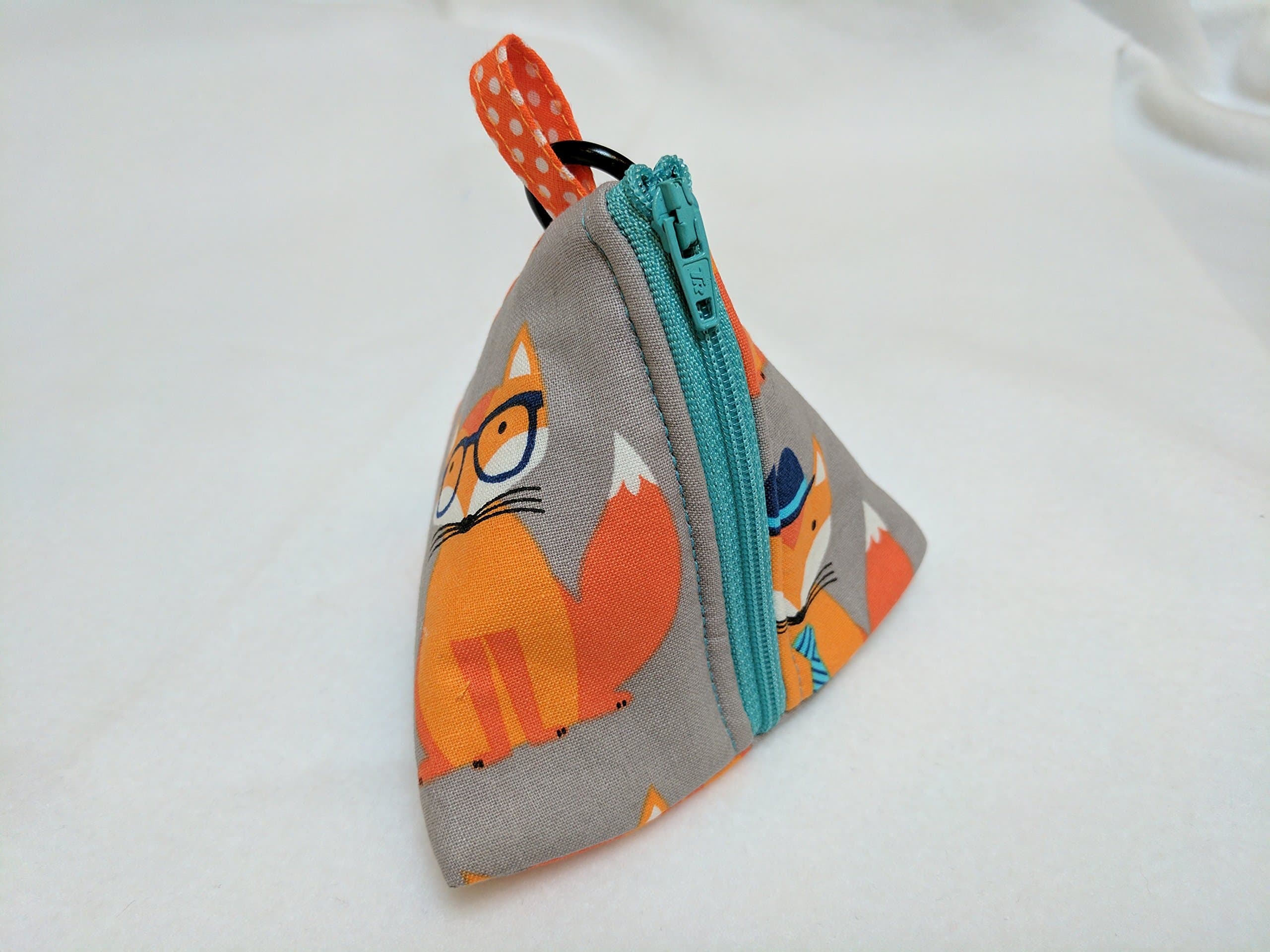 Fox Mini Pouch Bag - Zip up Purse. Handmade zip up triangular purse made using a lovely fox print on a grey/taupe background. Perfect to carry small amounts of money / cosmetic items (lipstick, eyeshadow) / keys etc, Book Bag accessory - lots of people buy these to carry dog treats or as a dispenser for dog poop bags, easily attaches to dogs lead - The mini pouch bag comes with a metal Carabiner clip attached.