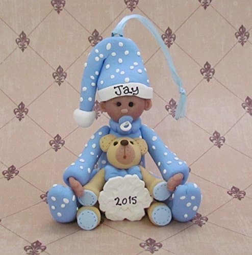 Baby boy with teddy bear and snowflake ornament